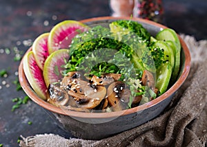 Vegan buddha bowl dinner food table. Healthy vegan lunch bowl. Grilled mushrooms, broccoli, radish salad