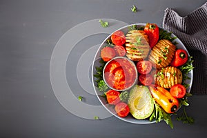 Vegan buddha bowl. healthy lunch bowl with hasselback potato, av