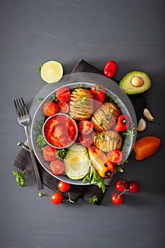 Vegan buddha bowl. healthy lunch bowl with hasselback potato, av