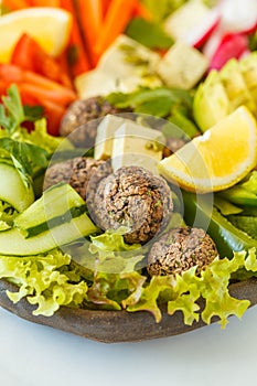 Vegan buddha bowl salad with vegetables, tofu, black beans meatballs and avocado. Healthy vegan food concept. photo