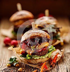 Vegan burger, carrot burger, homemade burger with carrot cutlet, grilled bell pepper, cherry tomatoes, red onion chutney, lettuce,