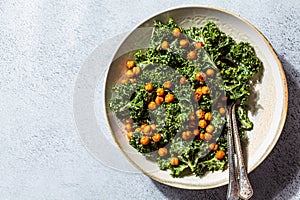 Vegan caesar salad. Fried chickpea salad with kale in white bowl, top view. Vegan food concept photo