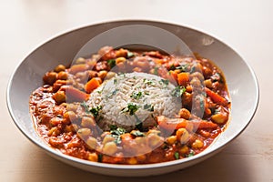 Vegan chickpeas curry. close up of fresh vegetarian indian curry known as chana masala with basmati rice and coriander leaves on