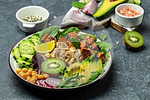 Vegan Chinese and Japanese salad with vegetables and fried tofu. buddha bowl. Vegan lunch salad, Food recipe background. Close up