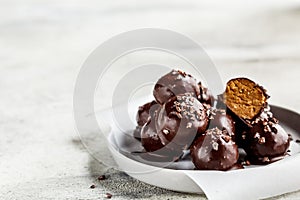 Vegan Chocolate energy Balls with peanut butter on gray plate