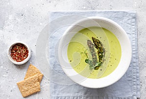 Vegan cream soup with asparagus in ceramic bowl