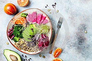 Vegan, detox Buddha bowl with quinoa, micro greens, avocado, blood orange, broccoli, watermelon radish, alfalfa seed sprouts.