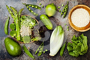 Vegan, detox green Buddha bowl recipe with quinoa, cucumber, broccoli, asparagus and sweet peas. photo
