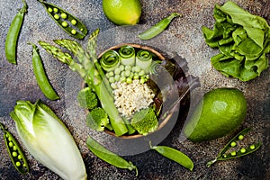 Vegan, detox green Buddha bowl recipe with quinoa, cucumber, broccoli, asparagus and sweet peas.