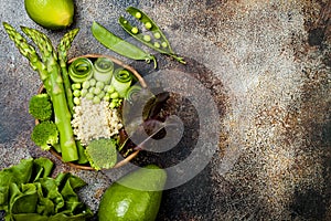 Vegan, detox green Buddha bowl recipe with quinoa, cucumber, broccoli, asparagus and sweet peas.