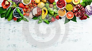 Vegan food banner. Fresh vegetables and fruits and berries on a white wooden background.