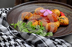 Vegan food, fried tofu ball cook with tomato sauce for vegetarian meal