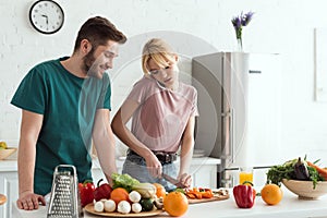 vegan girlfriend talking by smartphone while preparing meal