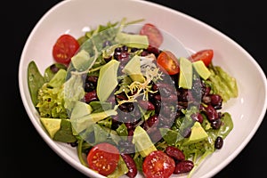 Vegan green salad with avocado and beans