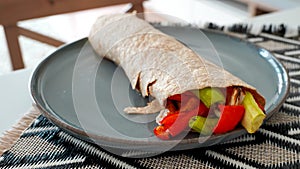 Vegan grilled vegetable wrap on gray plate