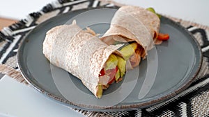 Vegan grilled vegetable wrap on gray plate