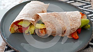 Vegan grilled vegetable wrap on gray plate