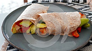 Vegan grilled vegetable wrap on gray plate