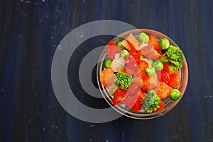 Vegan Healthy Food concept. Bowl with Vegetables. Frozen Colorful Vegetables. Brocolli, Carrots, Peas, Pepper. Top View.