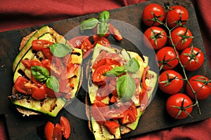 Vegan healthy food with grilled zucchini and fresh tomato