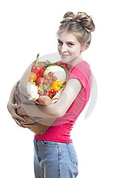 Vegan Healthy Lifestyle. Caucasian Blond Girl Holding Eco Paper Bag with Vegetables and Groceries In Casual Clothing On White