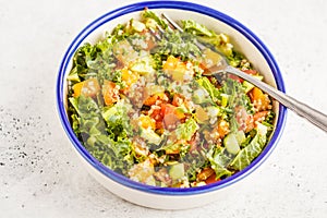 Vegan healthy rainbow salad with quinoa, tofu, avocado and kale.