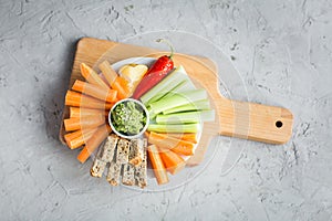 Vegan healthy snacks: guacamole, carrots, celery