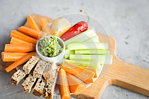 Vegan healthy snacks: guacamole, carrots, celery