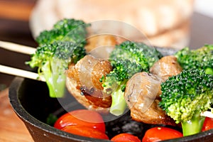 Vegan kebabs with seitan and broccoli on wooden skewers