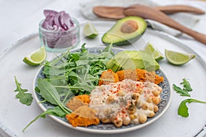 Vegan lunch bowl with quinoa, hummus, chickpeas, avocado