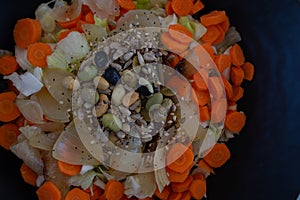 Vegan lunch. Carrot, lettuce, cabbage, onion and seeds salad