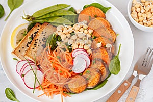 Vegan lunch, salad with vegetables, tofu, baked sweet potato, sp