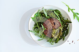 Vegan meatless soy cutlet with pesto and salad