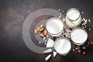 Vegan non dairy alternative milk, nuts and oat milk top view.