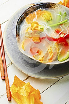 Vegan noodle soup with zucchini flowers