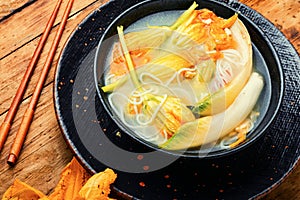 Vegan noodle soup with zucchini flowers