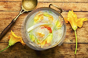 Vegan noodle soup with zucchini flowers