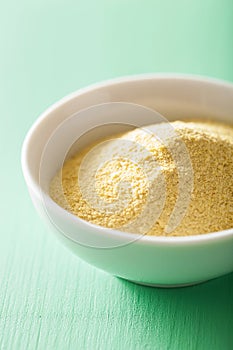 Vegan nutritional yeast flakes in bowl