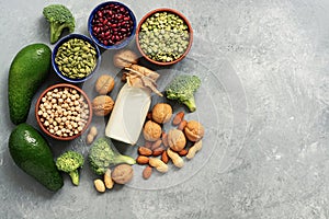 Vegan protein source. Healthy foods rich in protein for vegan and vegetarian, vegetables, milk, legumes, seeds, nuts on a gray