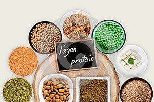 Vegan protein sources. Top view on a white wooden background.