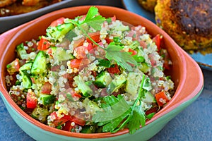 Vegan quinoa salad served in earthen bowl