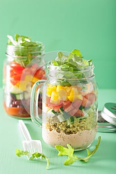 Vegan quinoa vegetable salad in mason jars