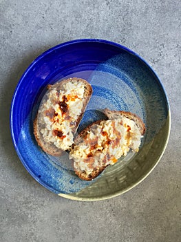 Vegan smashed chickpea salad on sourdough toast with harissa drizzle