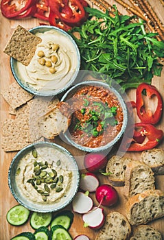 Vegan snack board. Flat-lay of Vegetarian dips hummus, babaganush, muhammara