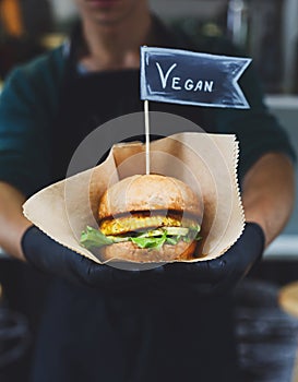 Vegan snacks - burger with text label in hands