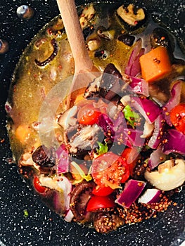 Vegan soup cooking from scratch with quinoa and veggies