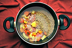 Vegan soup with lentils and fresh, organic vegetables in a pan