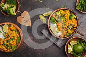 Vegan Sweet Potato Chickpea curry in wooden bowl on a dark background, top view. Healthy vegetarian food concept.