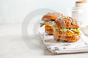 Vegan sweet potato or pumpkin burgers on white background. Veg photo