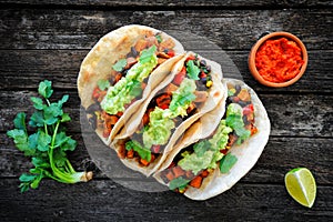 Vegan tacos with black beans, sweet potato and guacamole and tortillas flatbread